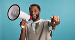 Portrait of black man, megaphone or smile for pointing to news announcement on blue background. You. microphone or selection for advertising sales, discount and call out for deal, promotion and offer