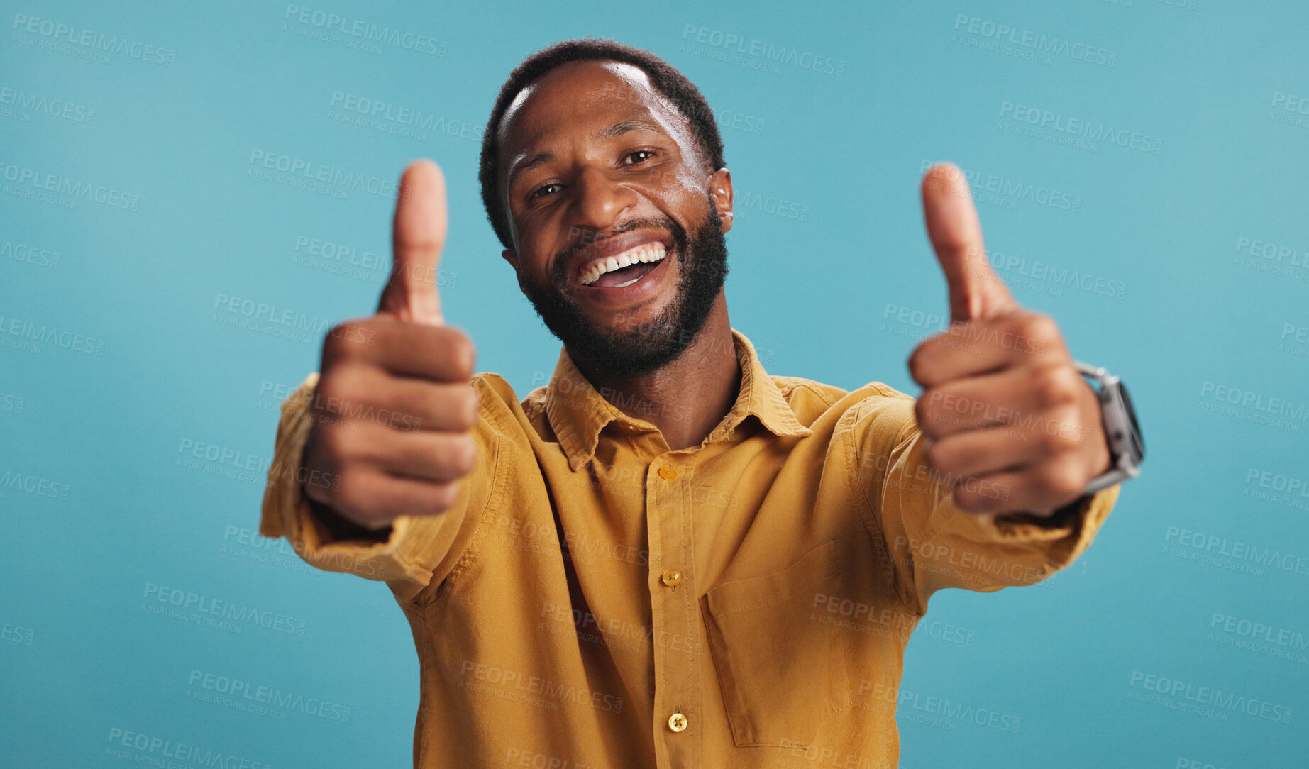 Buy stock photo Black man, thumbs up and like emoji in studio, promotion approval and yes icon for agreement. Male person, portrait and thank you for winner motivation on blue background, goals and great feedback