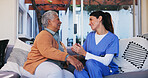 Senior, woman and nurse with conversation on sofa for healthcare support, medical advice and laughing together. Retirement home, caregiver and person on couch with assistance, trust or health service