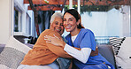 Old woman, nurse and portrait with hug on sofa for healthcare support, medical service and bonding together. Retirement home, caregiver and senior person with embrace, homecare and happy for recovery