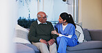 Senior, man and nurse with conversation in home for healthcare support, medical advice and consulting. Retirement care, caregiver and old person on couch with assistance, discussion or health service