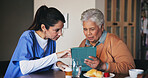 Tablet, consultation and nurse with senior patient at assisted living for diagnosis explanation. Digital technology, healthcare and caregiver with elderly woman for medical checkup in retirement home