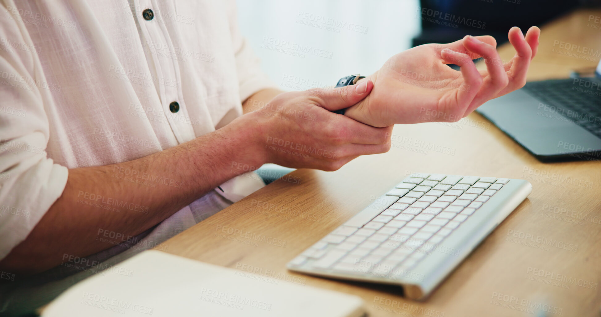 Buy stock photo Hands, man and wrist pain with keyboard in office for arthritis, carpal tunnel syndrome and typing injury. Person, strain with pressure and medical accident, ergonomic workspace and massage muscle  