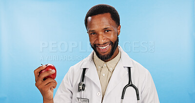 Buy stock photo Diet, doctor and black man with apple in portrait for nutrition, healthcare clinic or healthy food choice. Studio, blue background or happy African nutritionist with fruit for fibre and vitamin c