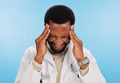 Buy stock photo Headache, doctor and black man in studio, stress and overworked on blue background. African person, medical and professional with migraine, healthcare and frustrated with burnout, pain and tension