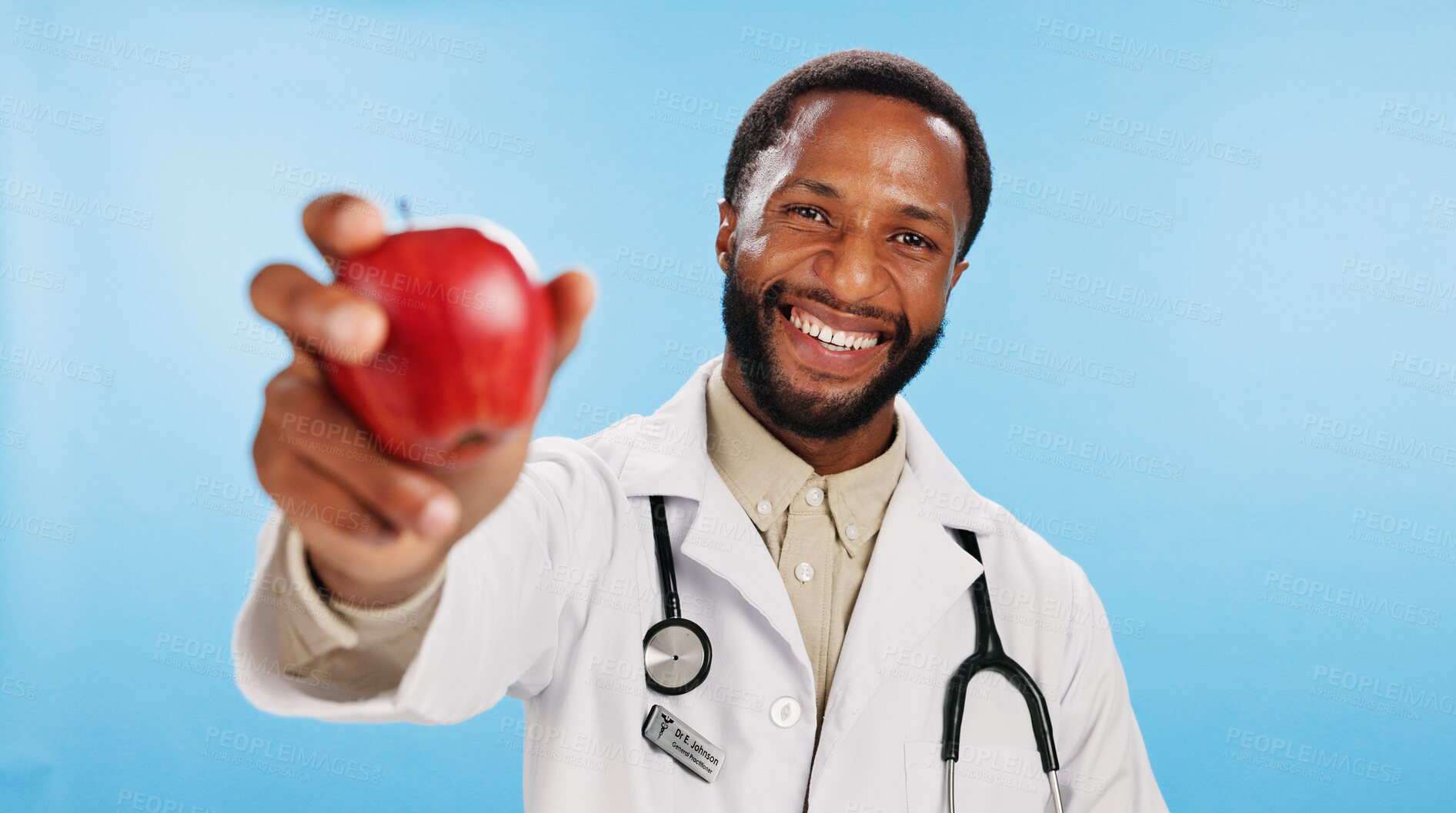 Buy stock photo Smile, doctor and black man with apple in portrait for nutrition, healthcare clinic or healthy food choice. Studio, blue background or happy African nutritionist with fruit for fibre and vitamin c