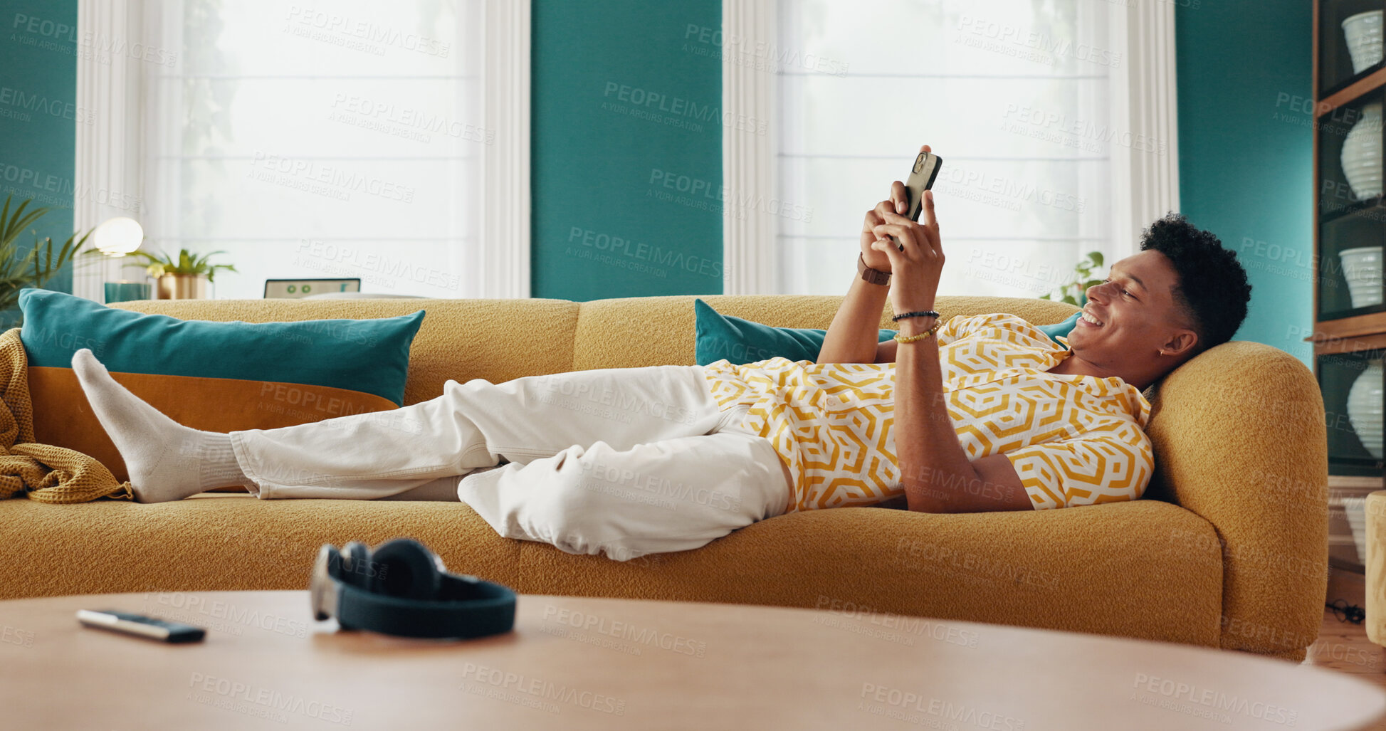 Buy stock photo Happy, man and relax on couch with phone at house for communication, dating website and chatting. Smile, male person and mobile for texting contact, online match and browse social media for streaming