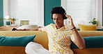 Home, listening and man on couch, headphones and relax with podcast, radio and calm in lounge. Person, apartment and guy on sofa, headset and music with sound, live streaming and song with audio