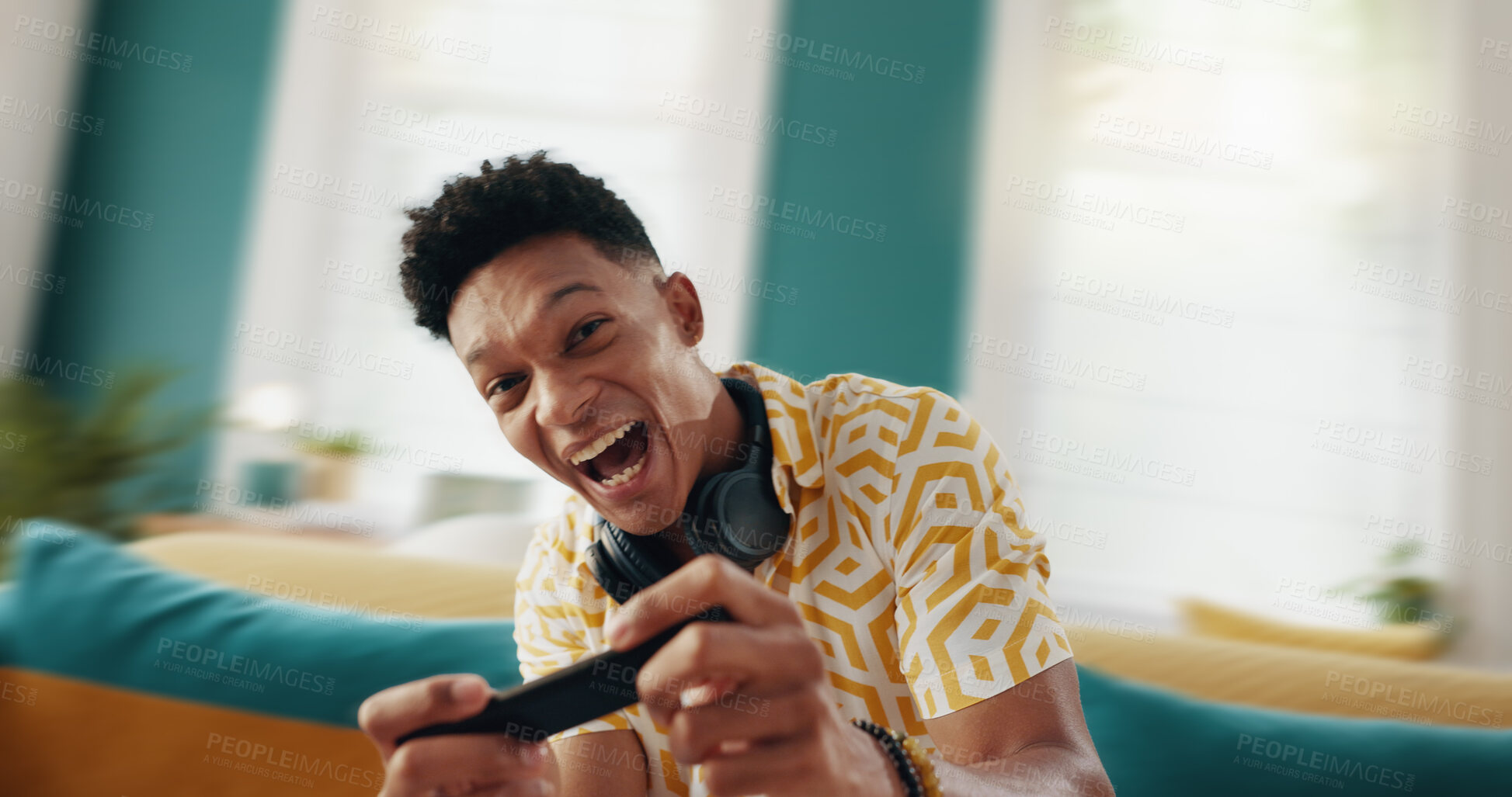 Buy stock photo Excited man, gamer and sofa with phone for race simulation, entertainment or mobile gaming subscription at home. Portrait, male person or happy player with smile or smartphone for virtual competition