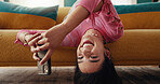 Phone, portrait and woman upside down in home, typing text and post on social media profile on internet. Mobile, face and girl on chat app for communication, check notification and relax on sofa