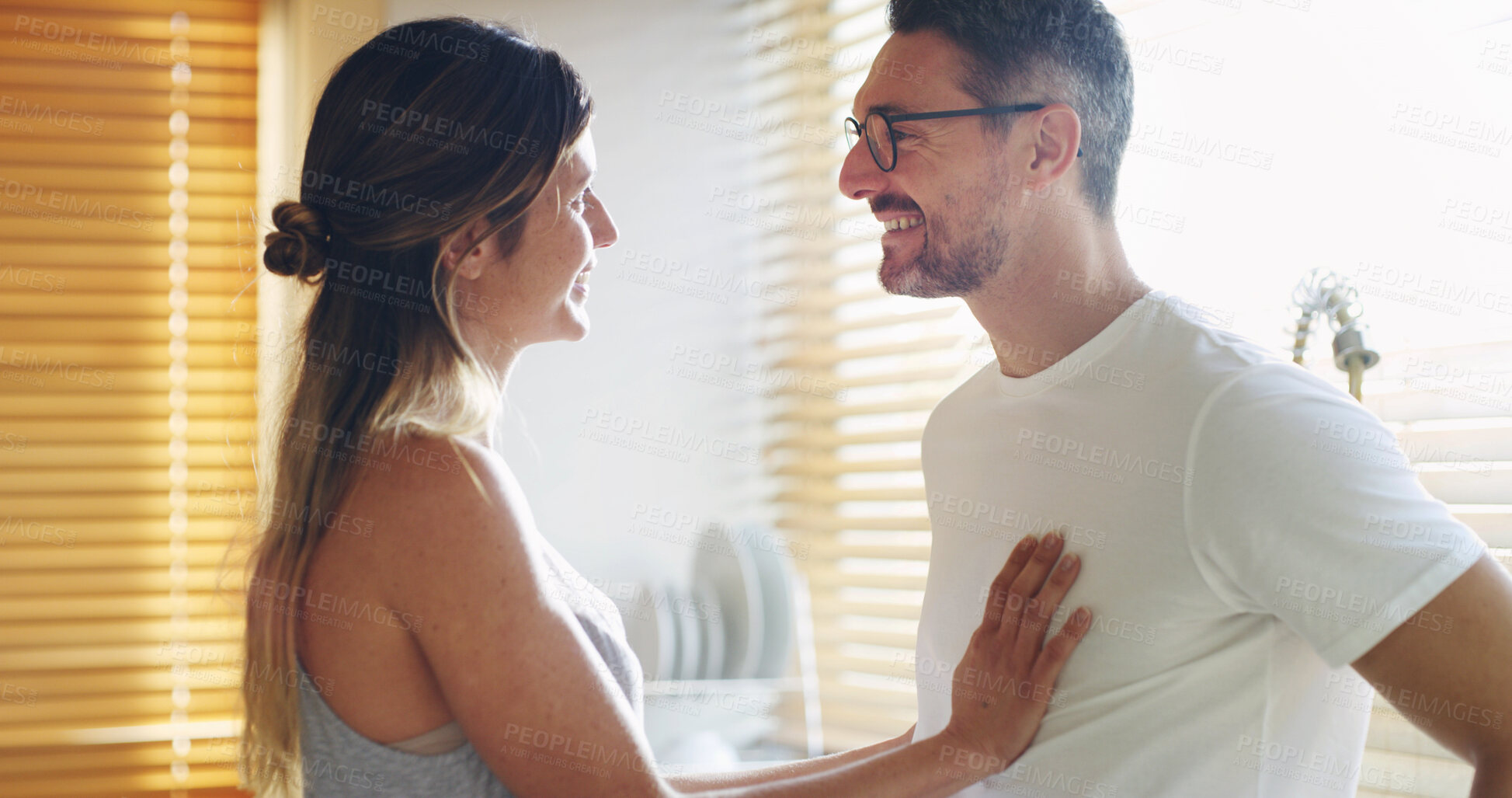 Buy stock photo Couple, happy and morning in kitchen, home and touch for care, love and conversation with memory. Mature man, woman and connection with bonding, smile and laughing with funny joke at apartment
