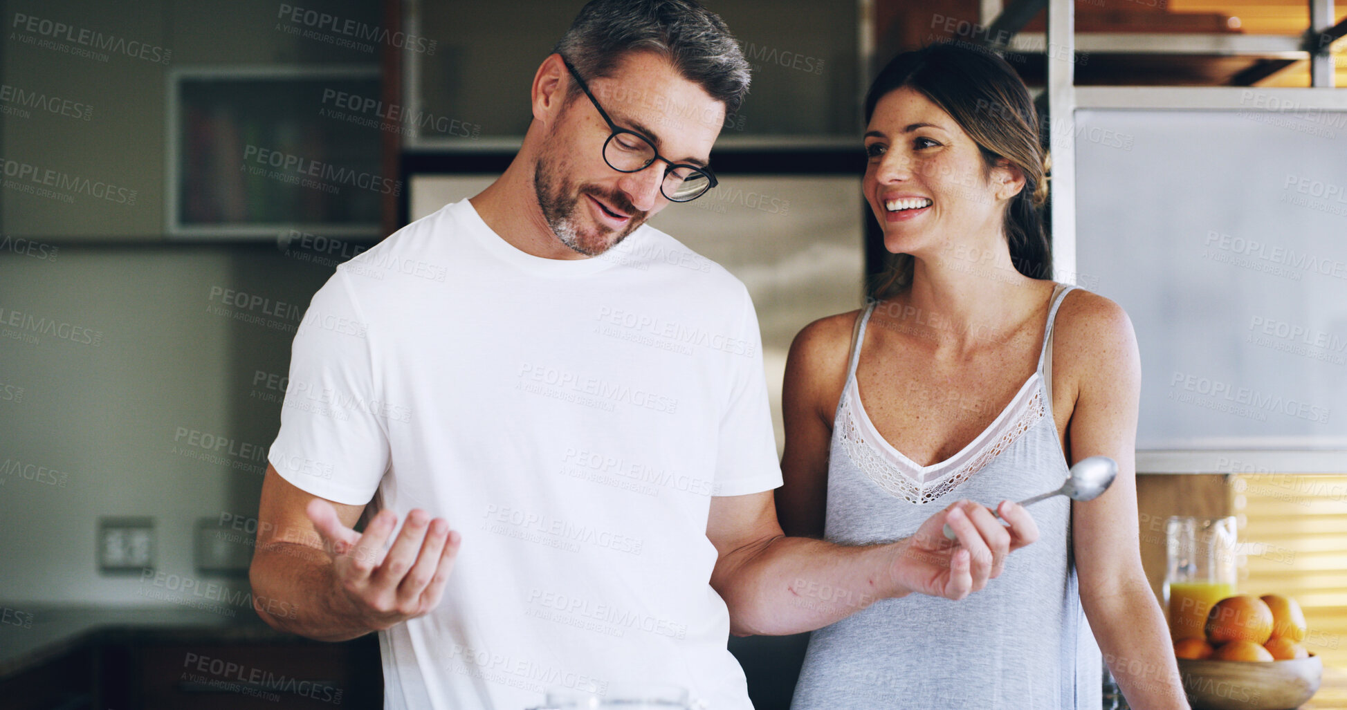 Buy stock photo Couple, happy and conversation in kitchen, morning or cooking breakfast for bonding in home. Mature man, woman and people with talk, laughing and funny joke with partner, chat and smile at apartment