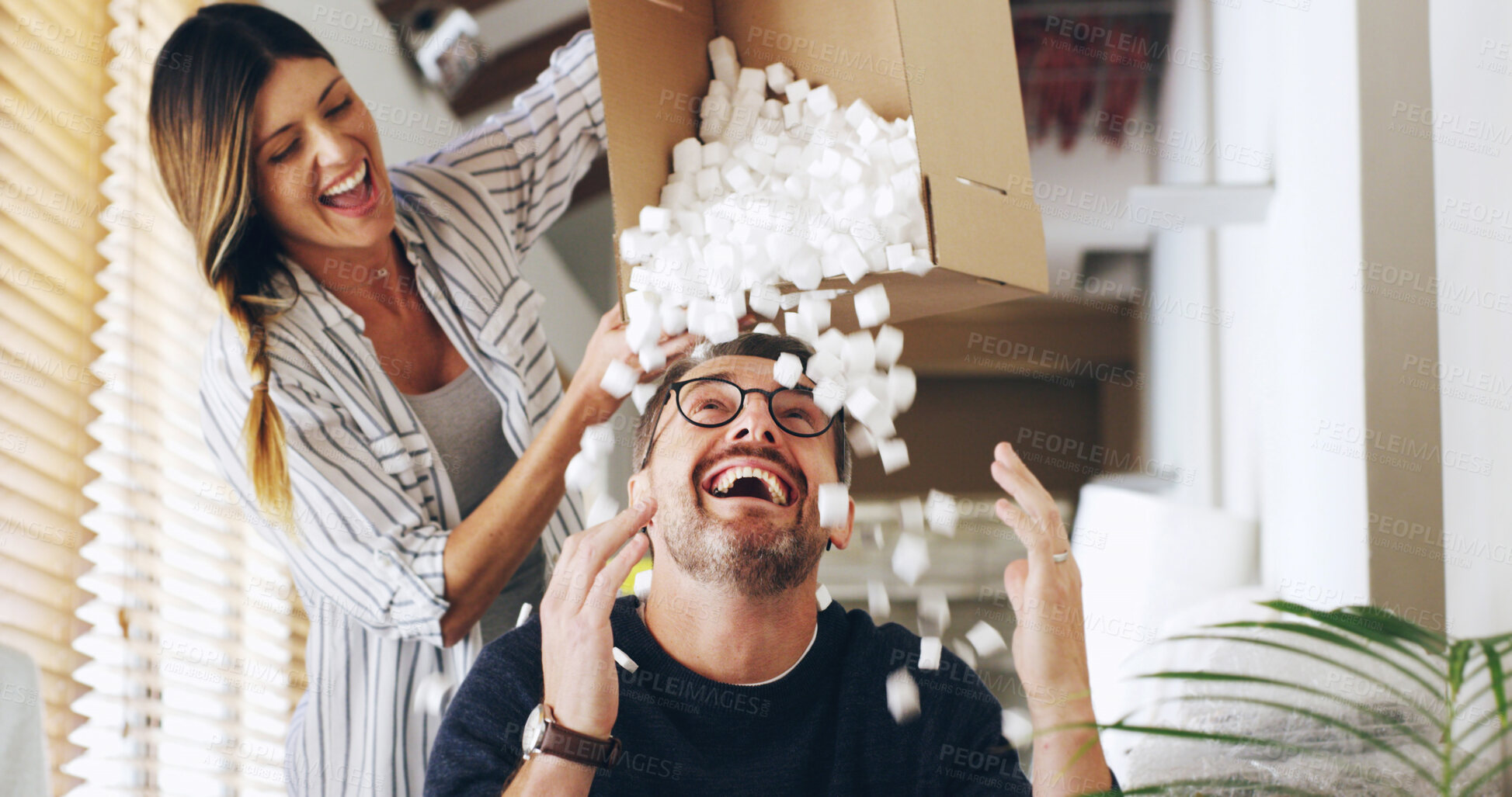 Buy stock photo Moving, boxes and couple with unpacking, foam and bonding together in new house. Man, woman and smile with game, playing and fun for real estate and dream home celebration for future mortgage