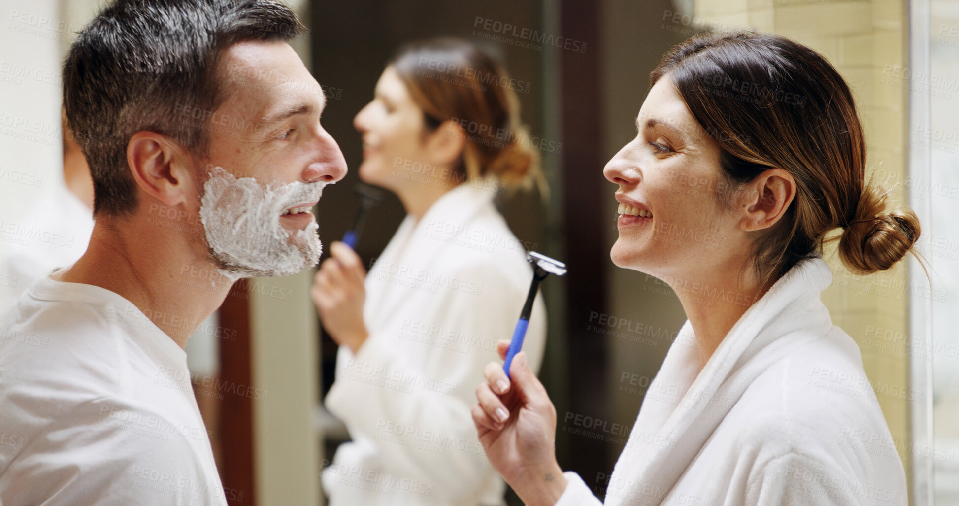 Buy stock photo Shaving, razor and couple in bathroom with beauty, help and facial treatment for hair removal. Support, skincare and woman with man in home with foam, marriage and grooming routine for hygiene