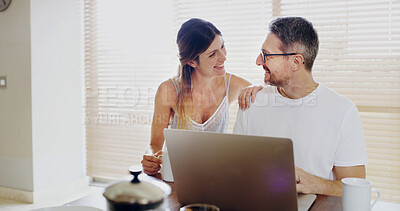 Buy stock photo Happy couple, talk and laptop in kitchen, breakfast and relax with coffee, streaming or social network in home. Mature man, woman and smile by computer, tea and love with funny memory at apartment