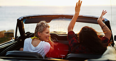 Buy stock photo Excited, freedom and road trip with woman friends in convertible for adventure, break or travel on blue sky. Hands raised, holiday and vacation with happy people in sports car for drive or transport