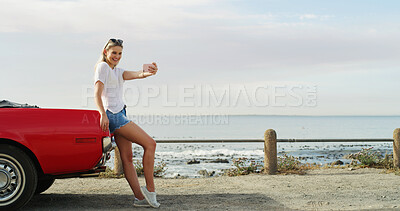 Buy stock photo Road trip, girl and selfie with car for holiday, travel and vacation outdoor by ocean. Convertible transport, woman and picture on journey for memory, social media post and excited influencer vlog