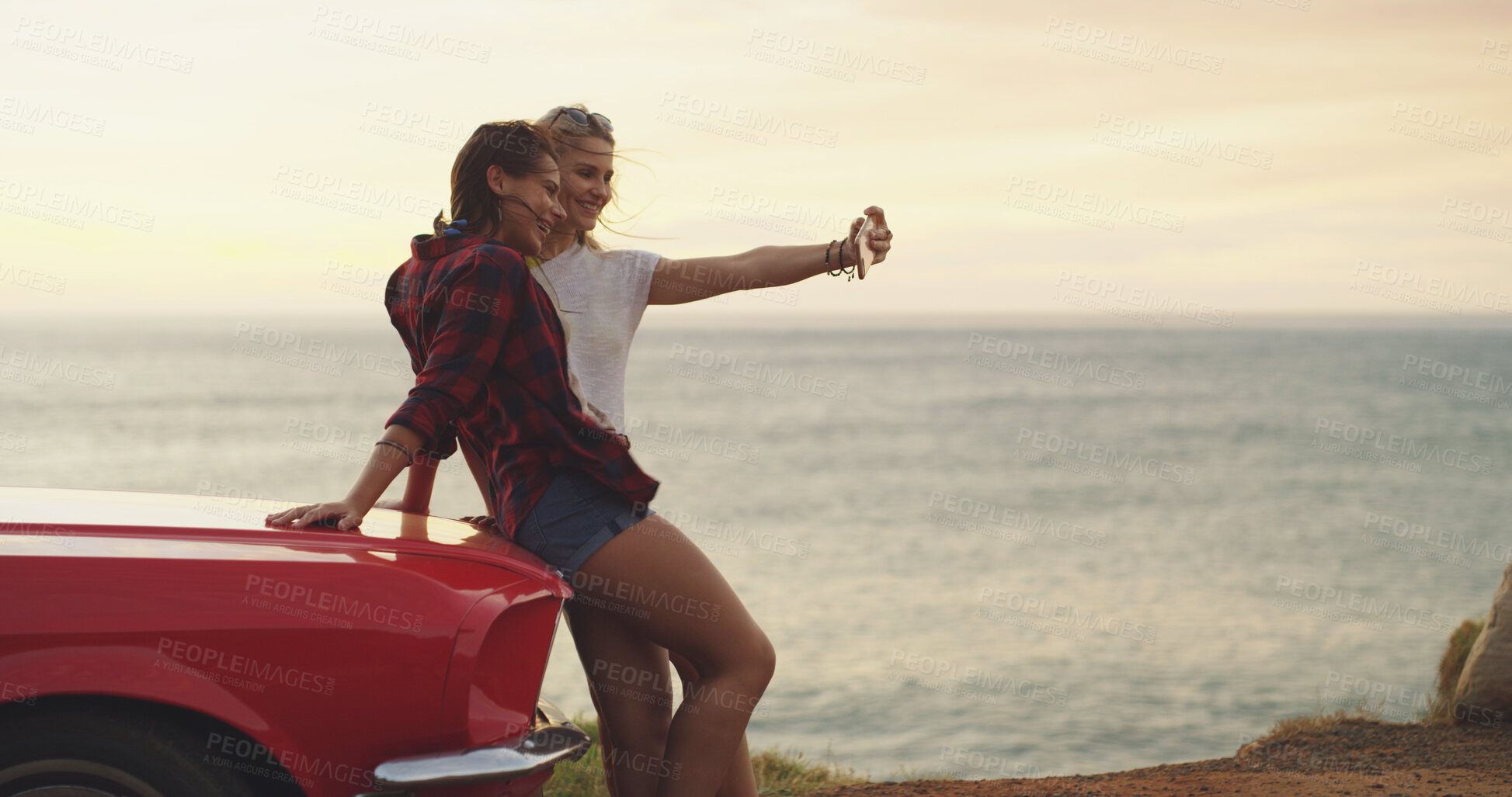 Buy stock photo Road trip, girls and selfie of friends at beach on car, vacation or travel on holiday outdoor. Transport, happy women and picture at ocean on journey for memory, social media post and laugh at sunset