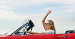 Freedom, road trip and smile of woman in convertible for adventure, break or travel on blue sky. Celebration, holiday and vacation with happy person in sports car for drive, journey or transport