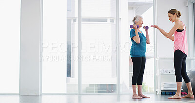 Buy stock photo Physical therapist, senior woman and dumbbell for fitness, healthy body or workout for wellness. Weightlifting, happy coach and exercise together for muscle, strength or help with recovery in gym
