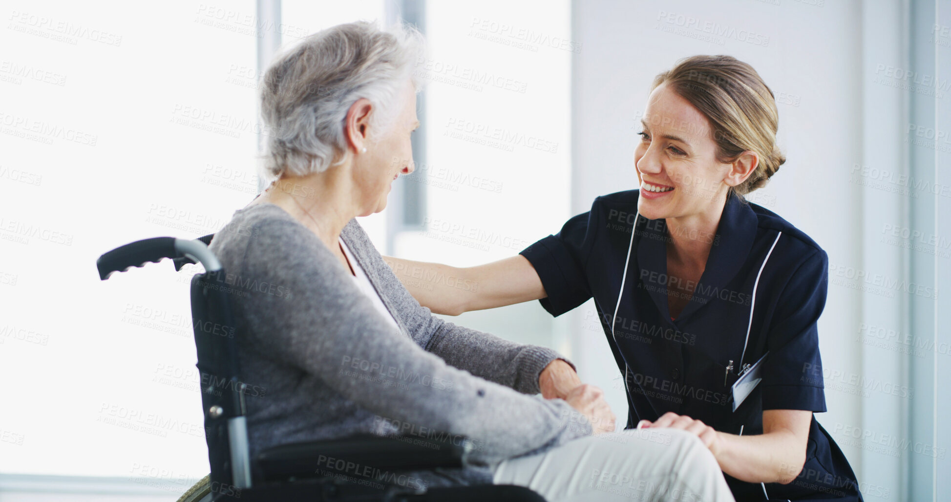 Buy stock photo Clinic, caregiver and kindness for woman with disability, smile and listening for emotional support. Healthcare, patient and senior person with wheelchair in nursing home, nurse and rehabilitation