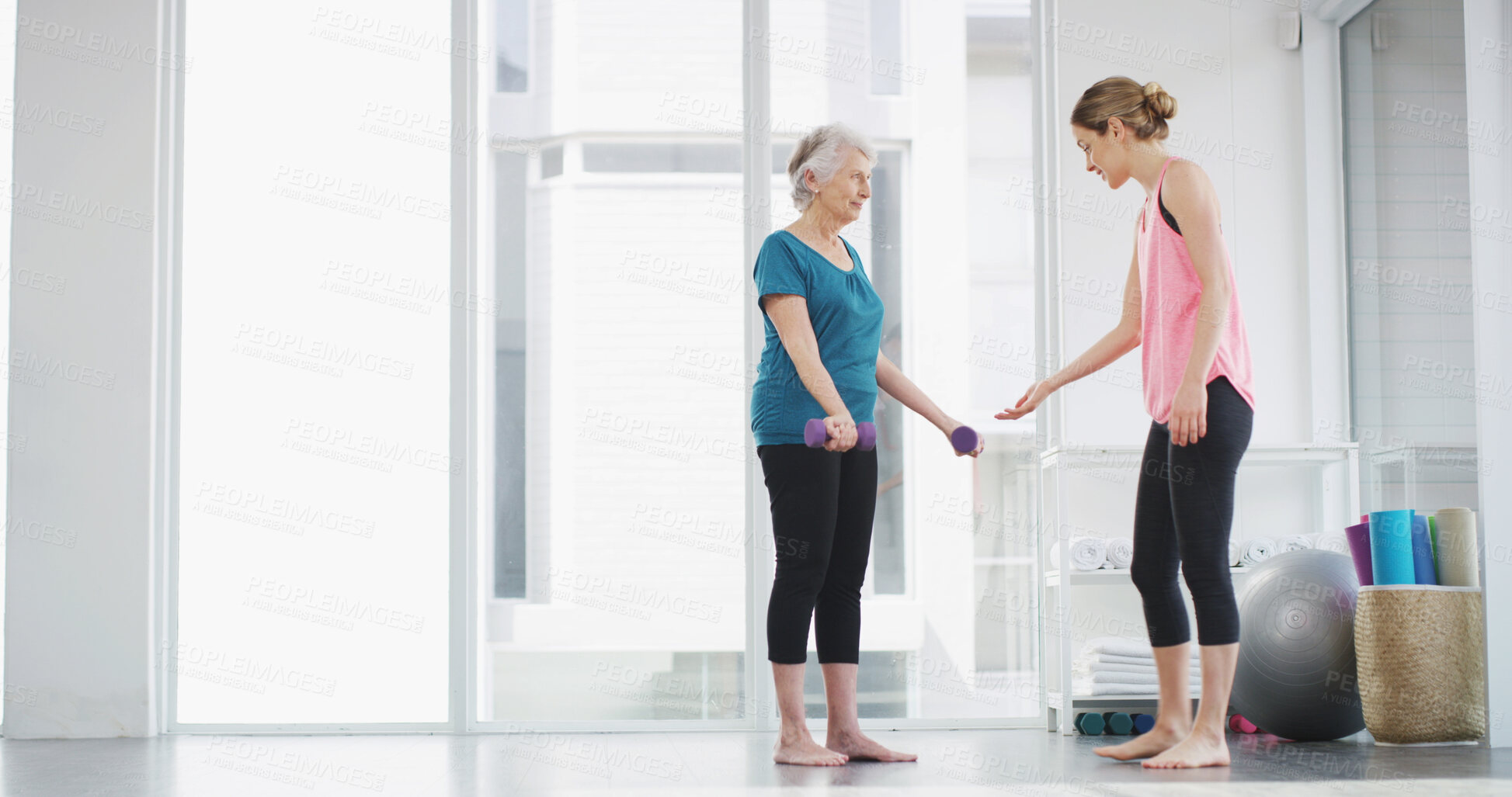 Buy stock photo Physiotherapy, elderly woman and dumbbell for fitness, healthy body or workout for wellness. Weightlifting, happy coach or exercise together for muscle, strength training or help with recovery in gym