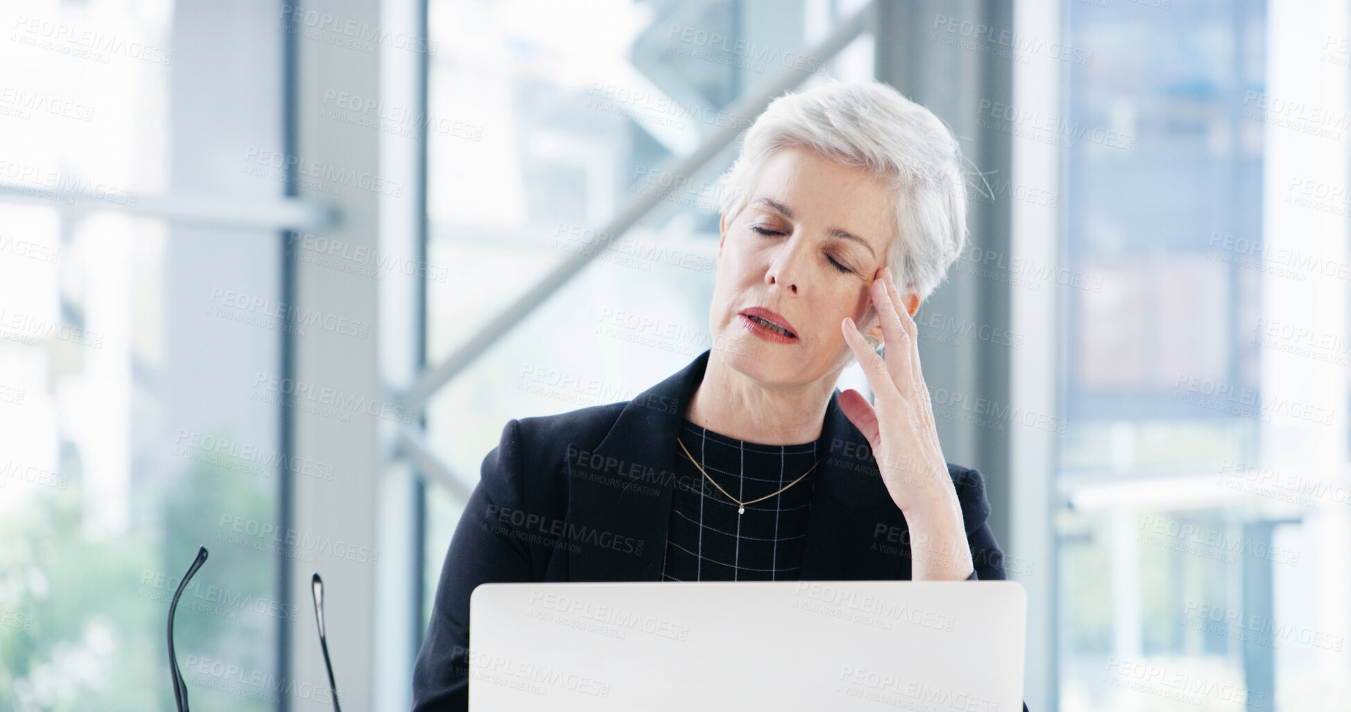 Buy stock photo Tired, laptop and mature woman with headache in office, burnout and overworked. Frustrated, employee or accountant with difficult audit, computer or migraine with anxiety, pain or stress with fatigue