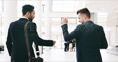 Buy stock photo Business, people and fist bump in office for greeting, welcome and playful deal in workplace. Back of men, friends and hand gesture in agency for teamwork, corporate collaboration and partnership