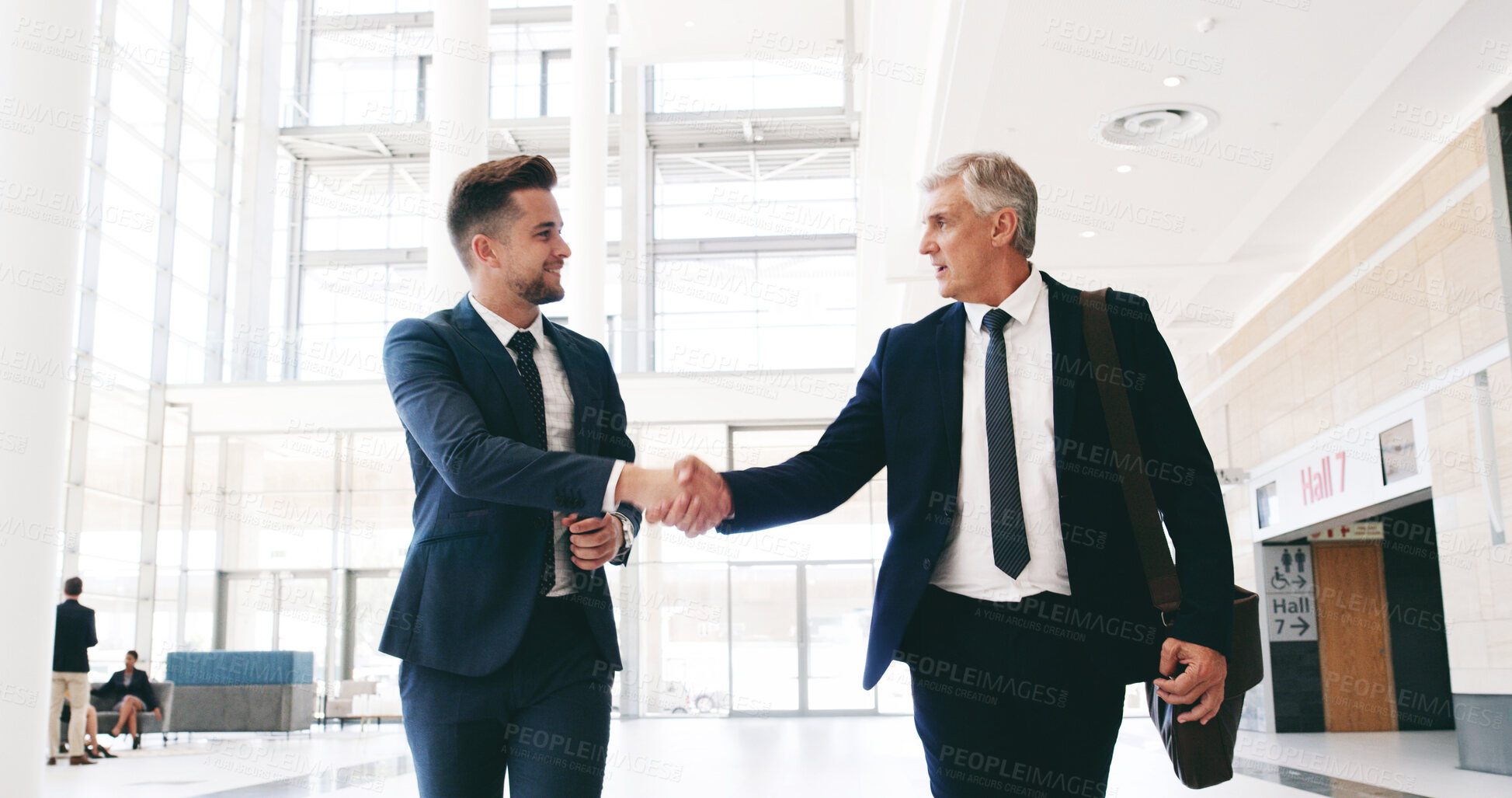 Buy stock photo Handshake, meeting and walking with business people in lobby of convention center for end of seminar. Conference, leaving and upskill development with employee men shaking hands for friendly greeting