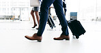 Business, suitcase and walking with passenger in airport terminal for international travel or trip. Legs, luggage and flight with corporate person at arrival or departure gate for boarding or journey