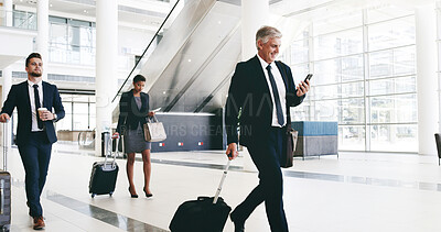 Buy stock photo Mature businessman, phone and suitcase at airport for international conference in lobby. Person, attorney and lawyer with mobile app, luggage and smartphone in hallway for booking, trip and schedule