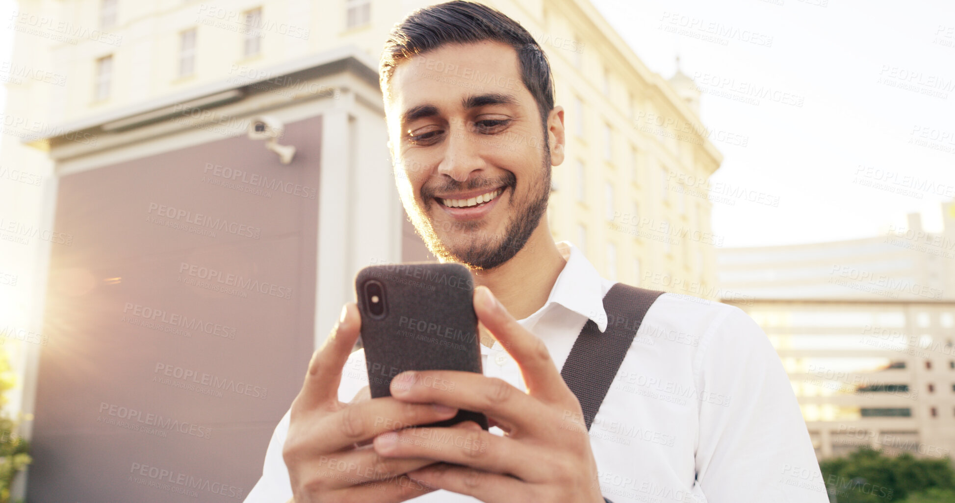 Buy stock photo Happy, businessman and typing with phone in city for communication, online texting or chatting. Man, tourist or traveler with smile on mobile smartphone for network, connectivity or app in urban town