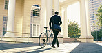 Businessman, bicycle and walking in city for travel, morning commute and eco friendly transport. Environmental lawyer, back and bike in town for reduced carbon footprint, climate conscious or journey