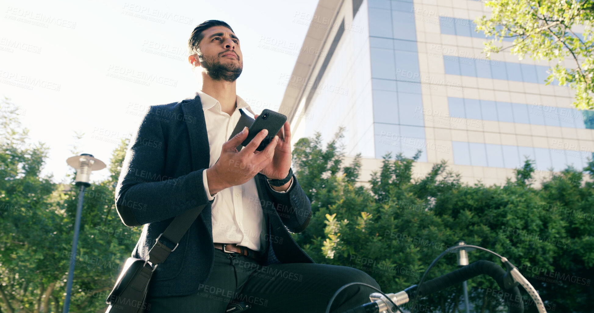 Buy stock photo Thinking, business and man with phone in city of real estate, showcase viewings and morning commute. Corporate, male agent and mobile maps with bike for commercial property, infrastructure conditions
