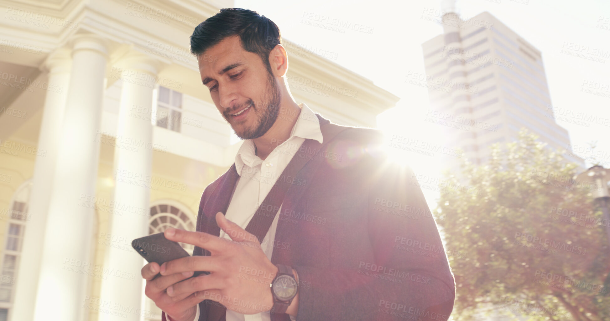 Buy stock photo Below, business and man with phone in city of real estate, viewings research and morning commute. Male agent, mobile and information of commercial property, listings negotiation and online navigation