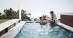 Travel, hotel and couple cheers at swimming pool for tropical vacation with fun, relax and bonding together. Drinks, man and woman at beach resort with toast, smile and love on valentines day holiday