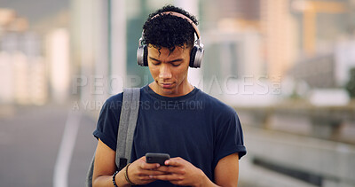 Buy stock photo Music, phone and walking with man on bridge in city to search map app for directions to location. App, social media and headphones message with African person in urban town for radio streaming