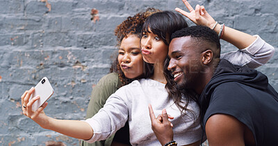 Buy stock photo Selfie, happy and group of friends by wall in city for memory, social media or profile picture on holiday. Funny, goofy and young influencers with photography for content creation vlog in town.