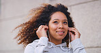 Exercise, music and thinking with woman runner outdoor in city for cardio or marathon training. Earphones, fitness and future with happy athlete person in urban town for start of workout routine