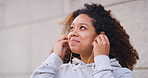 Fitness, music and thinking with woman runner outdoor in city for cardio or marathon training. Earphones, exercise and future with happy athlete person in urban town for start of workout routine