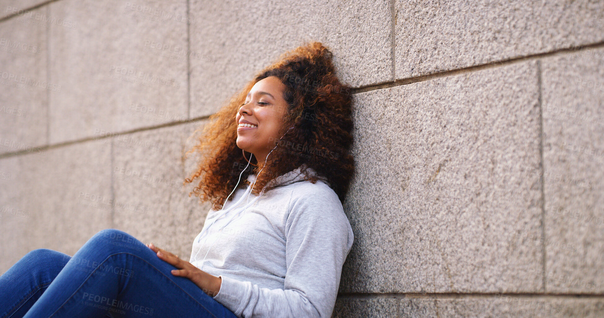Buy stock photo Wall, thinking and woman sitting with smile, outdoor and daydreaming with decision. Person, happiness and girl on ground, wonder and choice with options, thoughtful and solution with problem solving