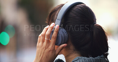 Buy stock photo Headphones, hand and woman in city with music for commuting to university in morning. Travel, audio tech and back of female student listening to online playlist, podcast or radio in urban town.