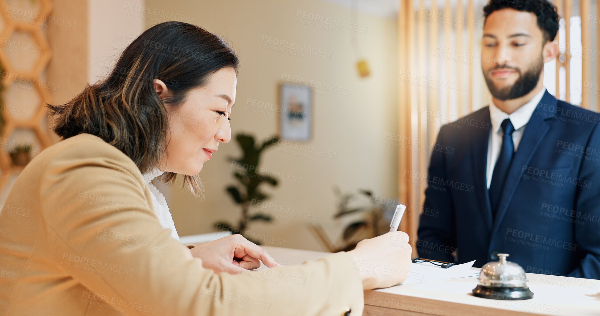 Buy stock photo Hotel, signature and woman at desk with man, paperwork and reception service for hospitality. Check in, registration and receptionist with client at counter for accommodation, booking or travel