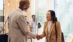 Handshake, introduction and smile with business people in lobby of office for friendly greeting. Hello, orientation and welcome with human resources manager and employee shaking hands for greeting