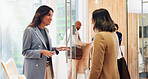 Business women, planning and team in hotel lobby for meeting, brainstorming or travel reservation. Collaboration, discussion and happy employees work together or supervision with hospitality manager