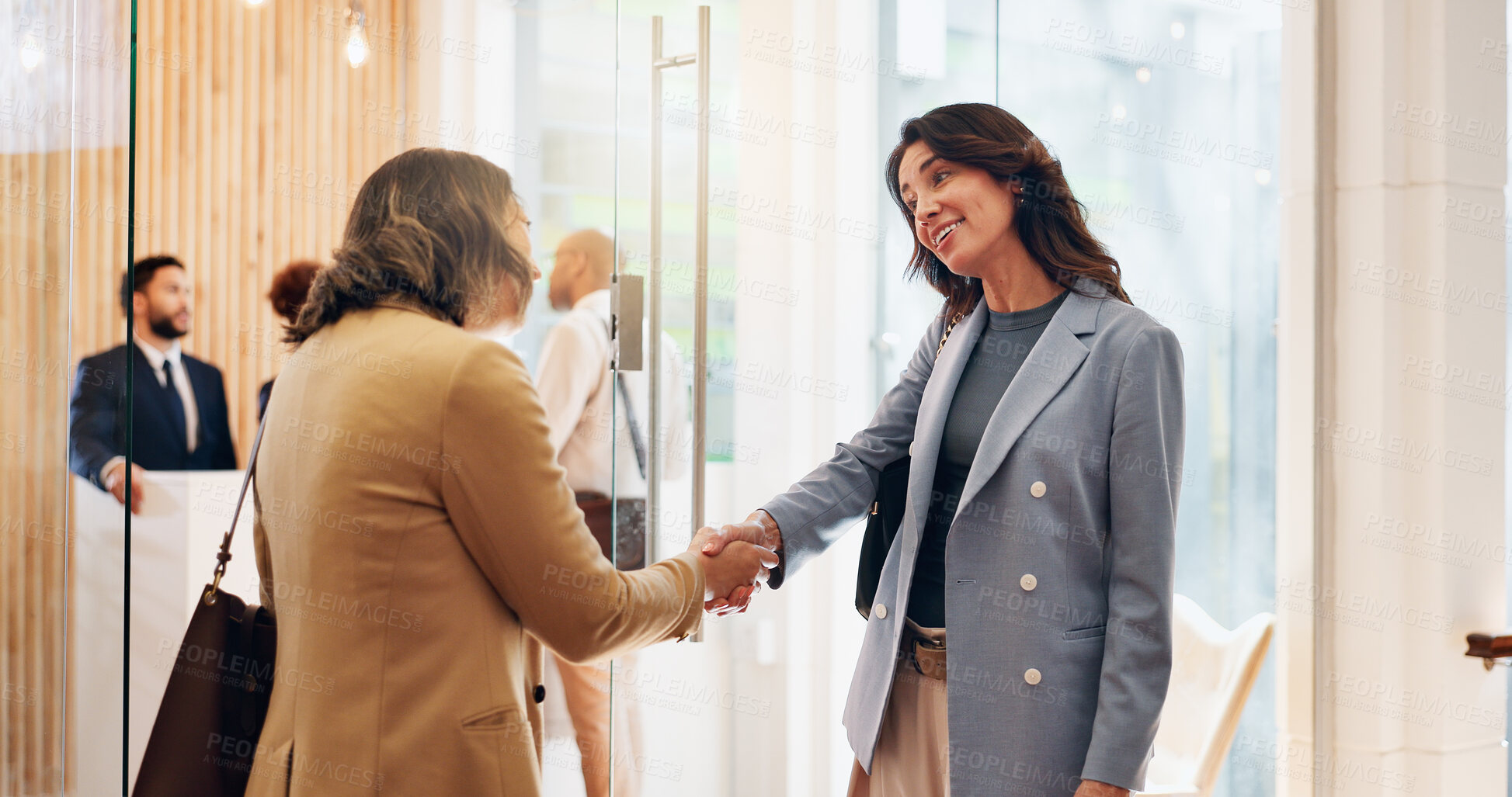 Buy stock photo Handshake, smile and welcome with business women in lobby of office for friendly greeting. Hello, introduction and recruitment with employee people shaking hands for human resources orientation