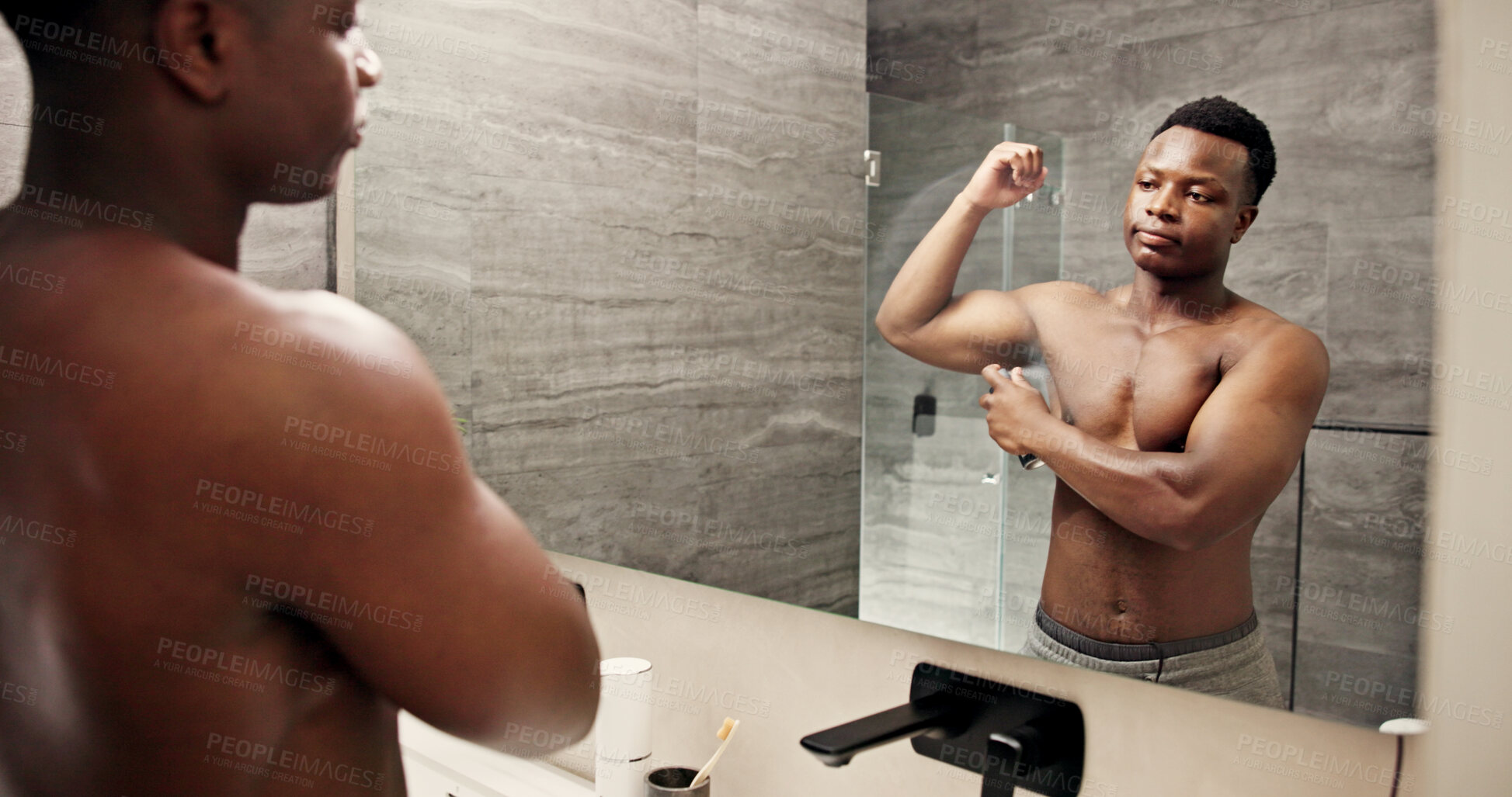 Buy stock photo Black man, mirror and spray deodorant in bathroom for hygiene, clean scent and underarm treatment. Male person, reflection and perfume with smelling fresh, grooming routine and sweat control at house