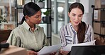 Box, documents and laptop for logistics with women in delivery or distribution office together. Inventory, order or shipping with supply chain employee team in workplace for checklist or ecommerce