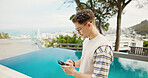 Pool, vacation and man with cellphone, travel and weekend break with internet. Hotel, summer holiday and person with smartphone, influencer and social media with connection, app and luxury resort