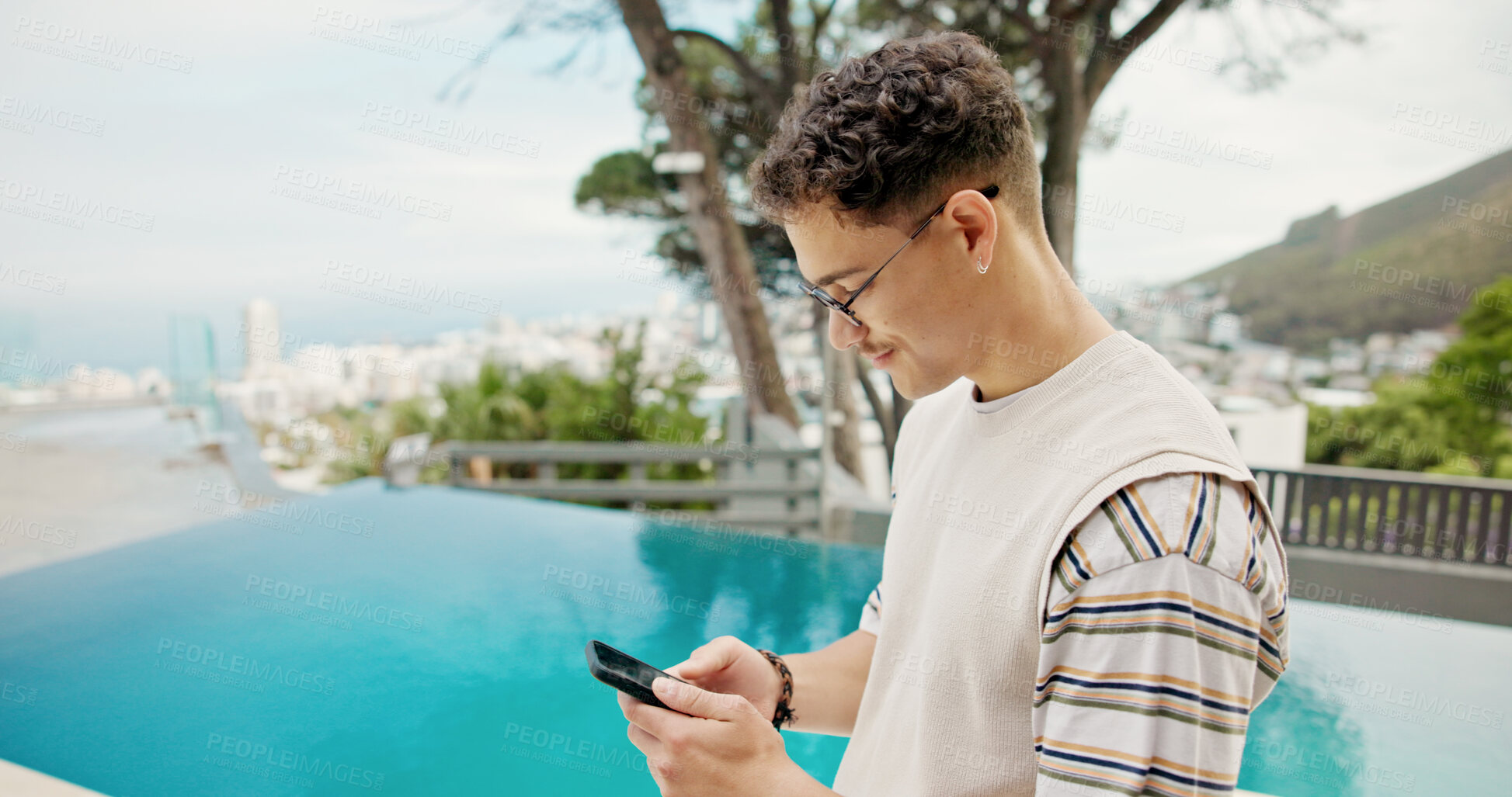 Buy stock photo Pool, vacation and man with smartphone, typing and weekend break with lodge. Person, summer holiday and guy with cellphone, influencer and social media with connection, message to contact or internet